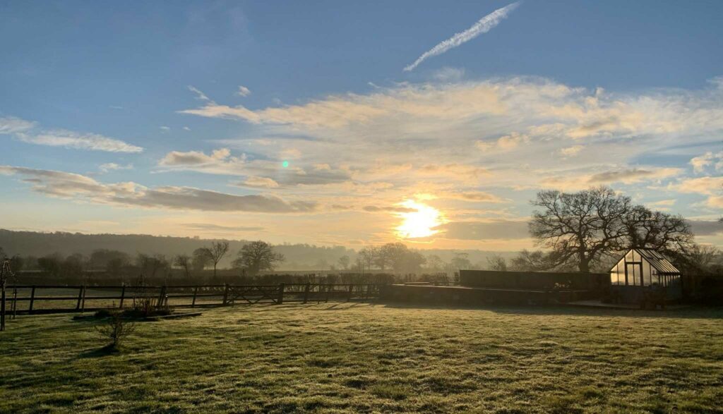 View of farm at sunset